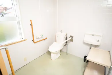 介護施設のトイレ・浴室。手すり、温便座、洗面台完備の福祉設計